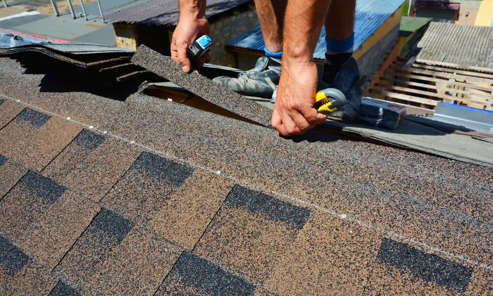 man installing new roofing of residential house